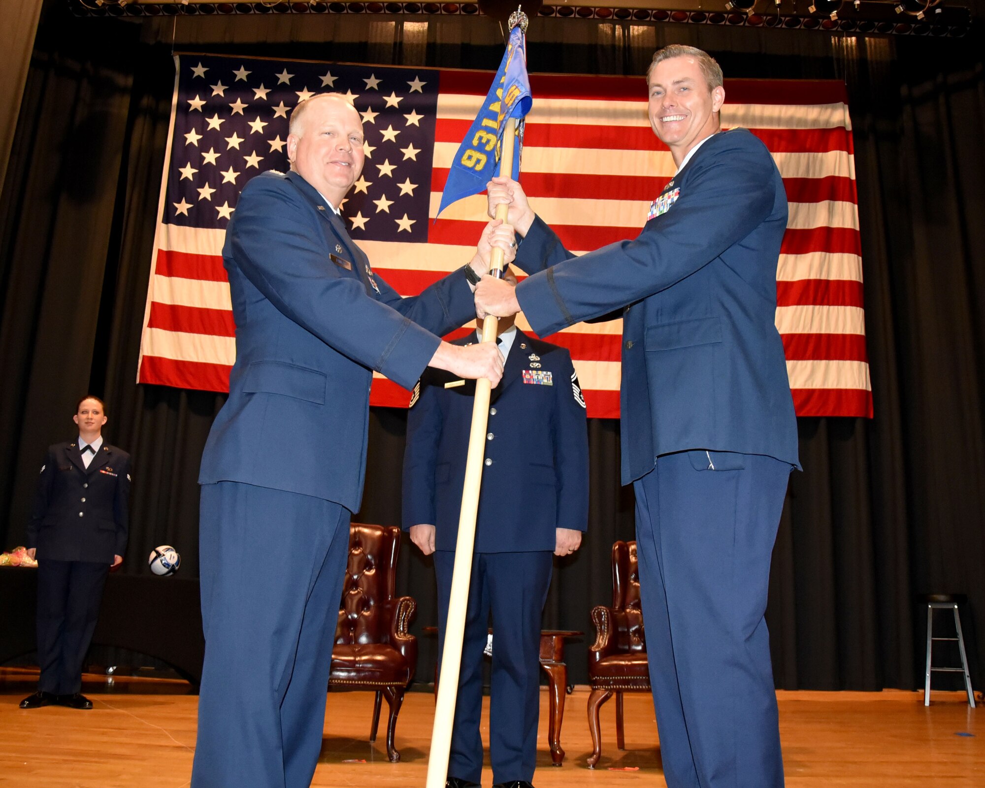 (Left to right) Col. Heath Fowler, 931st Maintenance Group commander, hands the 931st Maintenance Squadron guidon to Maj. Justin Franklin during an Assumption of Command Ceremony April 1, 2017, McConnell Air Force Base, Kan.  The transfer of the unit guidon symbolizes the transfer of authority from the previous commander to the new commander.  Franklin was previously the commander of the 513th Maintenance Squadron, 513th Air Control Wing, Tinker Air Force Base, Okla.  (U.S. Air Force photo by Tech. Sgt. Abigail Klein)