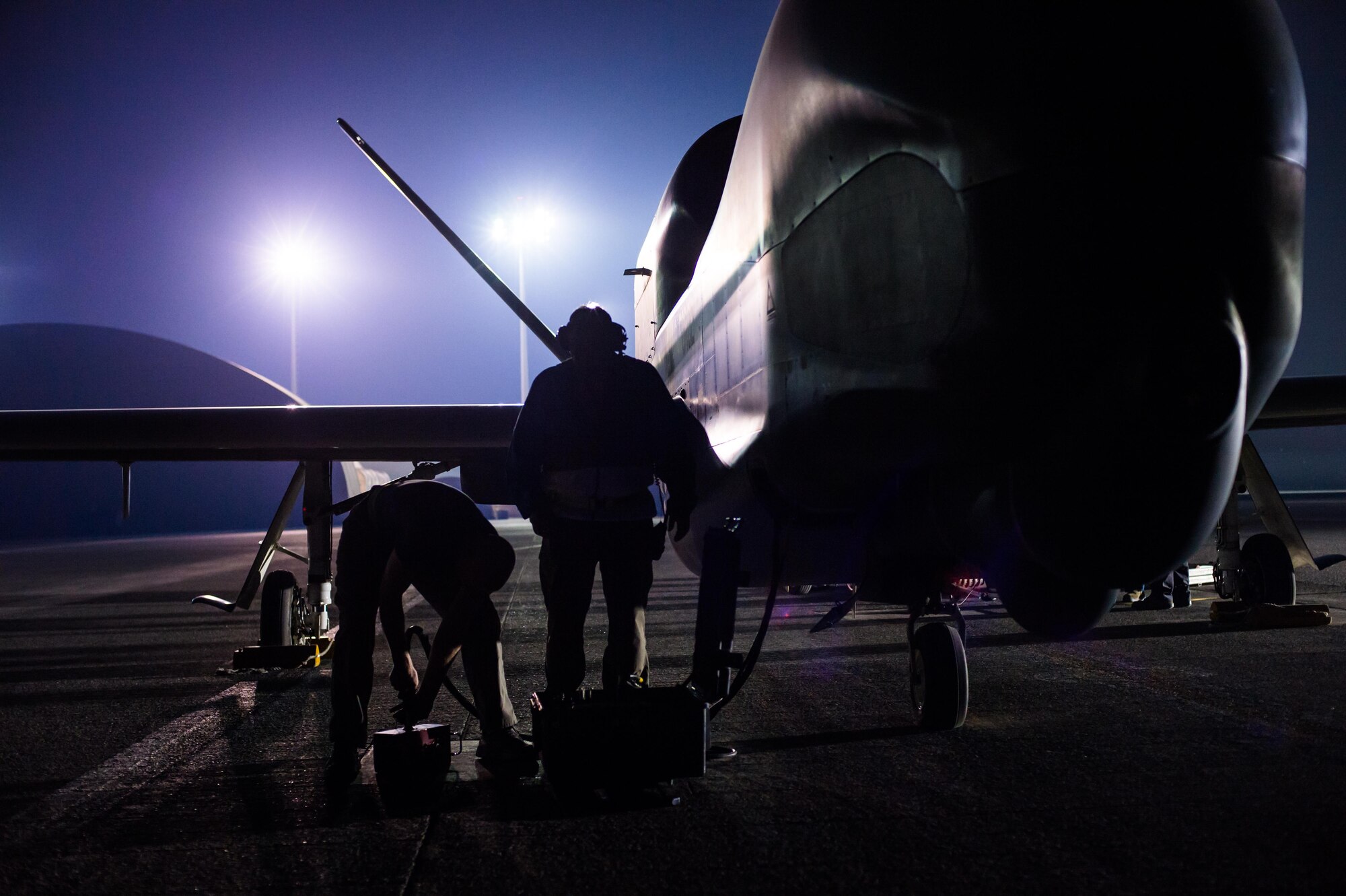 Members of the 380th Expeditionary Maintenance Squadron complete pre-flight checks on an EQ-4 Global Hawk equipped with a battlefield airborne communications node at an undisclosed location in Southwest Asia, March 31, 2017. This launch marked 1000 consecutive sorties without a maintenance cancel while supporting Combined Joint Task Force-Operation Inherent Resolve. These remotely piloted aircraft have provided a critical communication bridge between multi-national Coalition assets working to defeat ISIS in the area of responsibility. (U.S. Air Force/Senior Airman Tyler Woodward)