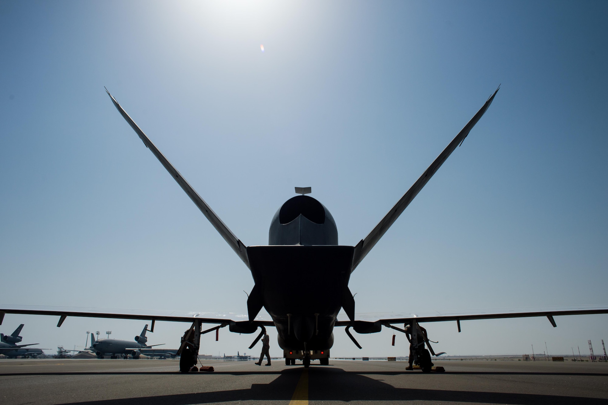 Members of the 380th Expeditionary Maintenance Squadron complete post-flight checks on an EQ-4 Global Hawk equipped with a battlefield airborne communications node at an undisclosed location in Southwest Asia, April 1, 2017. The completion of this mission marked 1000 consecutive sorties without a maintenance cancel while supporting Combined Joint Task Force-Operation Inherent Resolve. These remotely piloted aircraft have provided a critical communication bridge between multi-national Coalition assets working to defeat ISIS in the area of responsibility. (U.S. Air Force/Senior Airman Tyler Woodward)