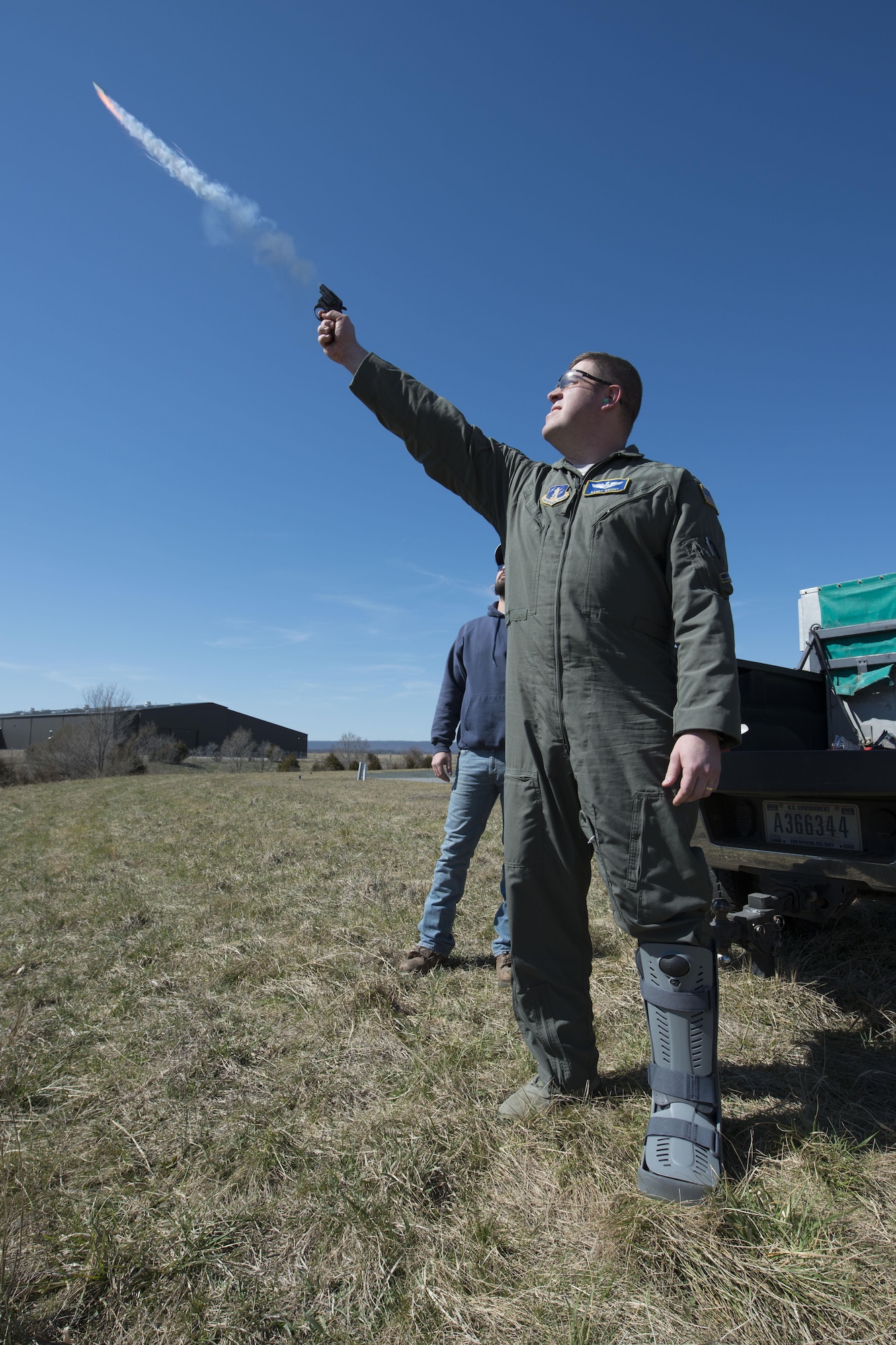 Maj. Randy Wright, a pilot and the chief of safety for the 167th Airlift Wing, fires a pyrotechnic from a small pistol. The pyrotechnics are similar to small firecrackers that make a pop or whistling sound. as part of a wildlife management course taught at the wing, March 23. Pyrotechnics are one of the tactics used to scare away birds from the airfield for the safety of the aircraft and the animals.(U.S. Air National Guard photo by Senior Master Sgt. Emily Beightol-Deyerle)