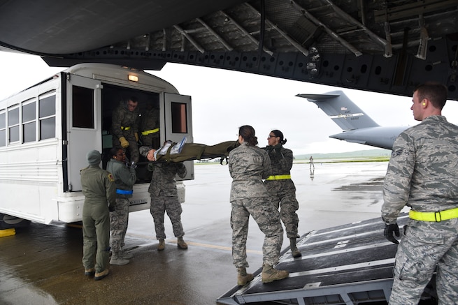 An aeromedical evacuation team litter carries a simulated patient onto a C-17 Globemaster III at Travis Air Force Base, Calif., March 24, 2017. This scenario took place the first day of the two-day aeromedical evacuation training exercise, Patriot Delta. (U.S. Air Force photo by Senior Airman Sam Salopek)