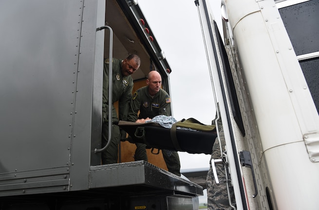An aeromedical evacuation team loads a patient into an ambulatory bus for transport at Travis Air Force Base, Calif., March 24, 2017. This scenario was part of the aeromedical evacuation training exercise, Patriot Delta. (U.S. Air Force photo by Senior Airman Sam Salopek)