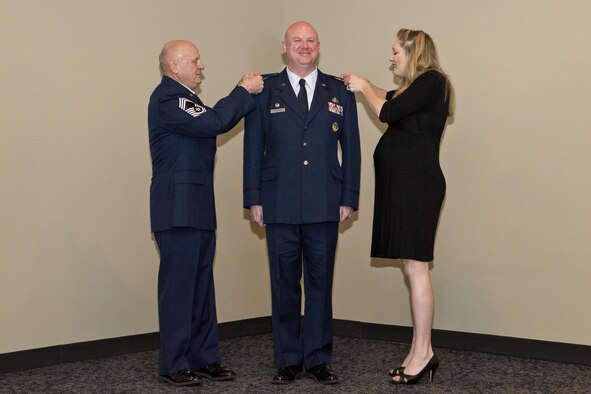 Stanley L. Stefancic III was promoted to the rank of colonel and assumed command of the 188th Intelligence, Surveillance and Reconnaissance Group March 1, 2017 at Ebbing Air National Guard Base, Fort Smith, Ark. Retired Chief Master Sgt. Stanley Stefancic Jr. and Lindsey Stefancic, spouse of Col. Stefancic, place the colonel insignia on Stefancic’s service coat.  It is an honorary tradition for the member’s family to pin the insignias during an officer’s promotion ceremony.  (U.S. Air National Guard photo by Senior Airman Matthew Matlock)