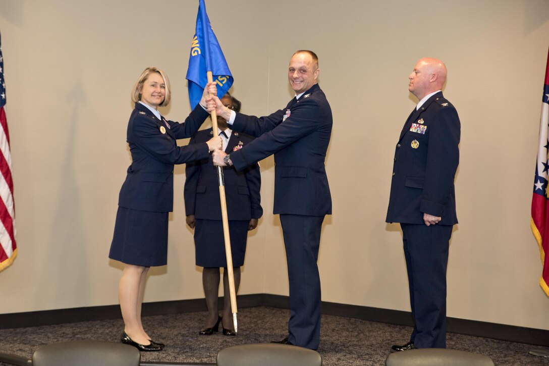 Col. Robert I. Kinney passes the 188th Intelligence, Surveillance and Reconnaissance Group guidon to Col. Bobbi J. Doreenbos, 188th wing commander, during the change of command ceremony March 1, 2017 at Ebbing Air National Guard Base, Fort Smith, Ark.  Kinney’s successor, Col. Stanley L. Stefancic III has served 24 years in the intelligence career field and has an extensive background in intelligence support to unit-level operations.    (U.S. Air National Guard photo by Senior Airman Matthew Matlock) 
