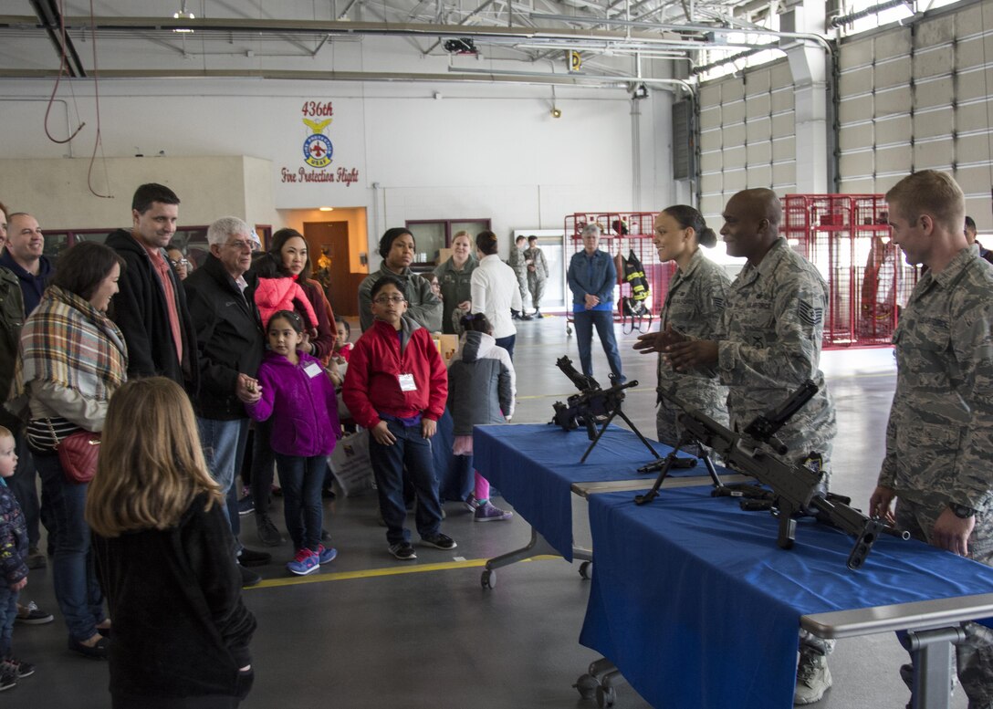 Security forces with the 436th Security Forces Squadron show an array of weapons to a group of 512th Airlift Wing family members on Dover Air Force Base, Del., April 1, 2017. Family members attended a Month of the Military Child event involving tours of a C-5M Super Galaxy, C-17 Globemaster III, fire station and a demonstration by military working dogs. (U.S. Air Force photo/Staff Sgt. Renee M. Jackson)