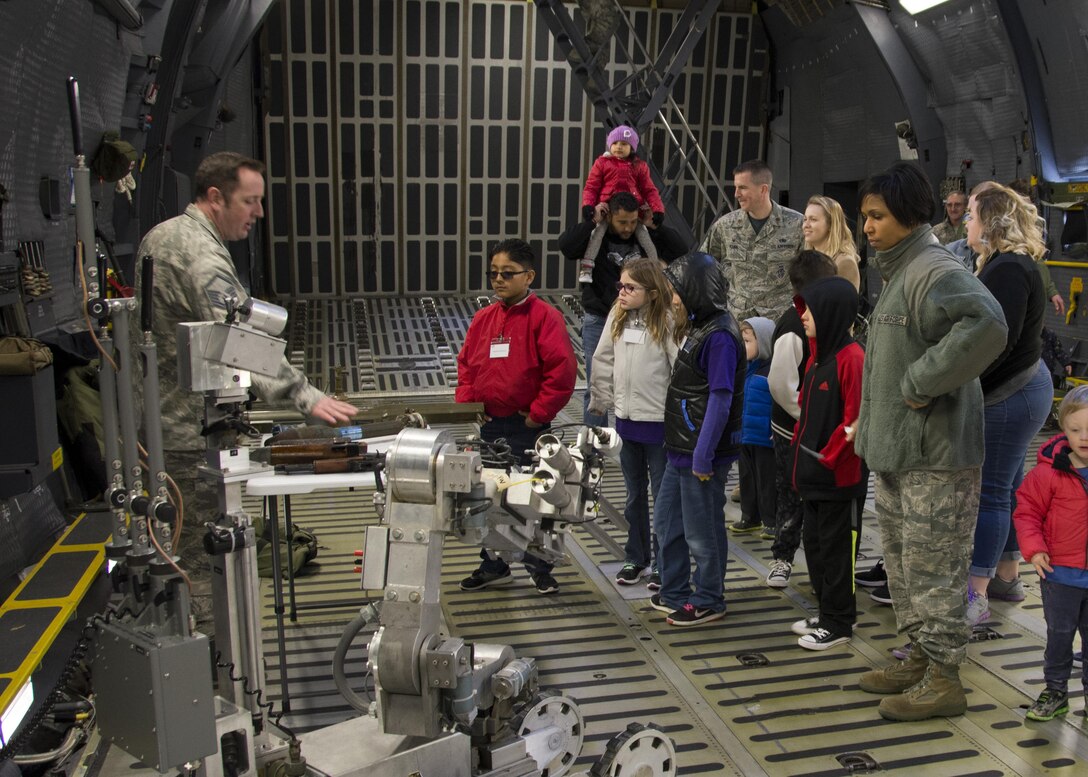 Master Sgt. Garth Muenter, 512th Civil Engineer Squadron, shows a table of disabled grenades and weapons to children and family members of the 512th Airlift Wing, Dover Air Force Base, Del., April 1, 2017. As part of a Month of the Military Child event, children and family members of 512th AW were able to see, touch and hear about what their loved one does for the Air Force Reserve. (U.S. Air Force photo/Staff Sgt. Renee M. Jackson)