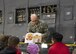 Chief Master Sgt. Bryan Ford, 512th Maintenance Group, reads a story to children onboard a C-5M Super Galaxy, Dover Air Force Base, Del., April 1, 2017. Family members attended a Month of the Military Child event involving tours of a C-5M Super Galaxy, C-17 Globemaster III, fire station and a demonstration by military working dogs. (U.S. Air Force photo/Staff Sgt. Renee M. Jackson)