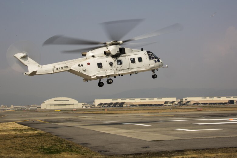 A Japanese MCH-101 airborne mine countermeasures helicopter lands on a heliport designated by Marine Air Control Squadron (MACS) 4 Detachment B during a cross-training exercise at Marine Corps Air Station Iwakuni, Japan, March 30, 2017. The purpose of the exercise was to simulate a forward arming and refueling points operation, where Marines communicated with Japan Maritime Self-Defense Force helicopter pilots to perform austere landings on a heliport that acted as an expeditionary runway. (U.S. Marine Corps photo by Lance Cpl. Carlos Jimenez)