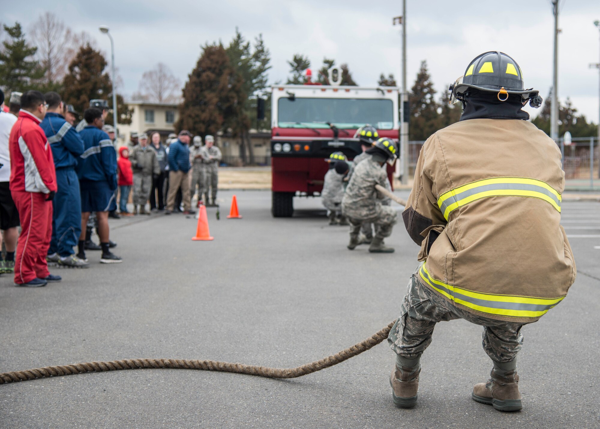 U.S. Air Force firefighters with the 35th Civil Engineer Squadron demonstrate pulling a firetruck during Wingman Day at Misawa Air Base, Japan, March 31, 2017. Wingman Day is held quarterly, and helps to enhance resiliency across the base. (U.S. Air Force Senior Airman Brittany A. Chase)