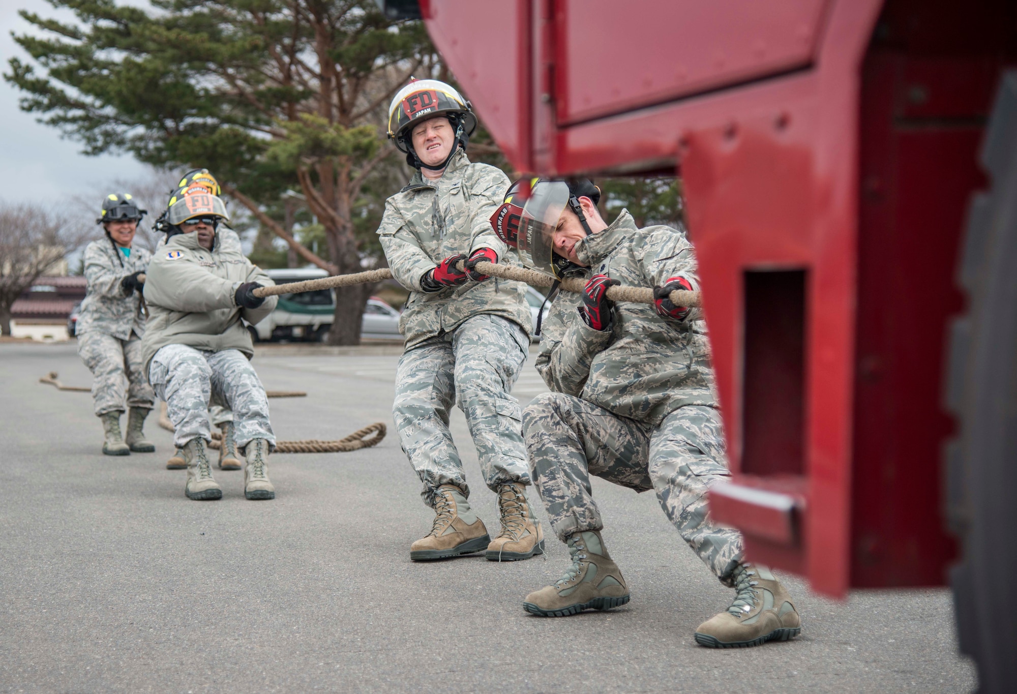Team Fighter Wing Leadership pulls a firetruck during Wingman Day at Misawa Air Base, Japan, March 31, 2017. Wingman Day encompassed multiple events throughout the day, including a firetruck pull where teams raced against the clock in hopes of getting the fastest time. (U.S. Air Force Senior Airman Brittany A. Chase)