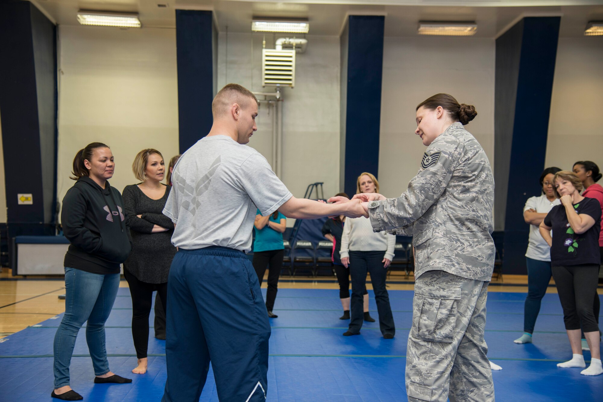 U.S. Air Force Senior Airman Christian Brancato, 35th Logistics Readiness Squadron fuel distribution operator, left, and Tech. Sgt. Sarah Quattrocchi, 35th Security Forces Squadron assistant flight chief, demonstrate self-defense moves during Wingman Day at Misawa Air Base, Japan, March 31, 2017. The self-defense class was open to the base populous to help give a better understanding of what to do incase of an attack. (U.S. Air Force Senior Airman Brittany A. Chase)