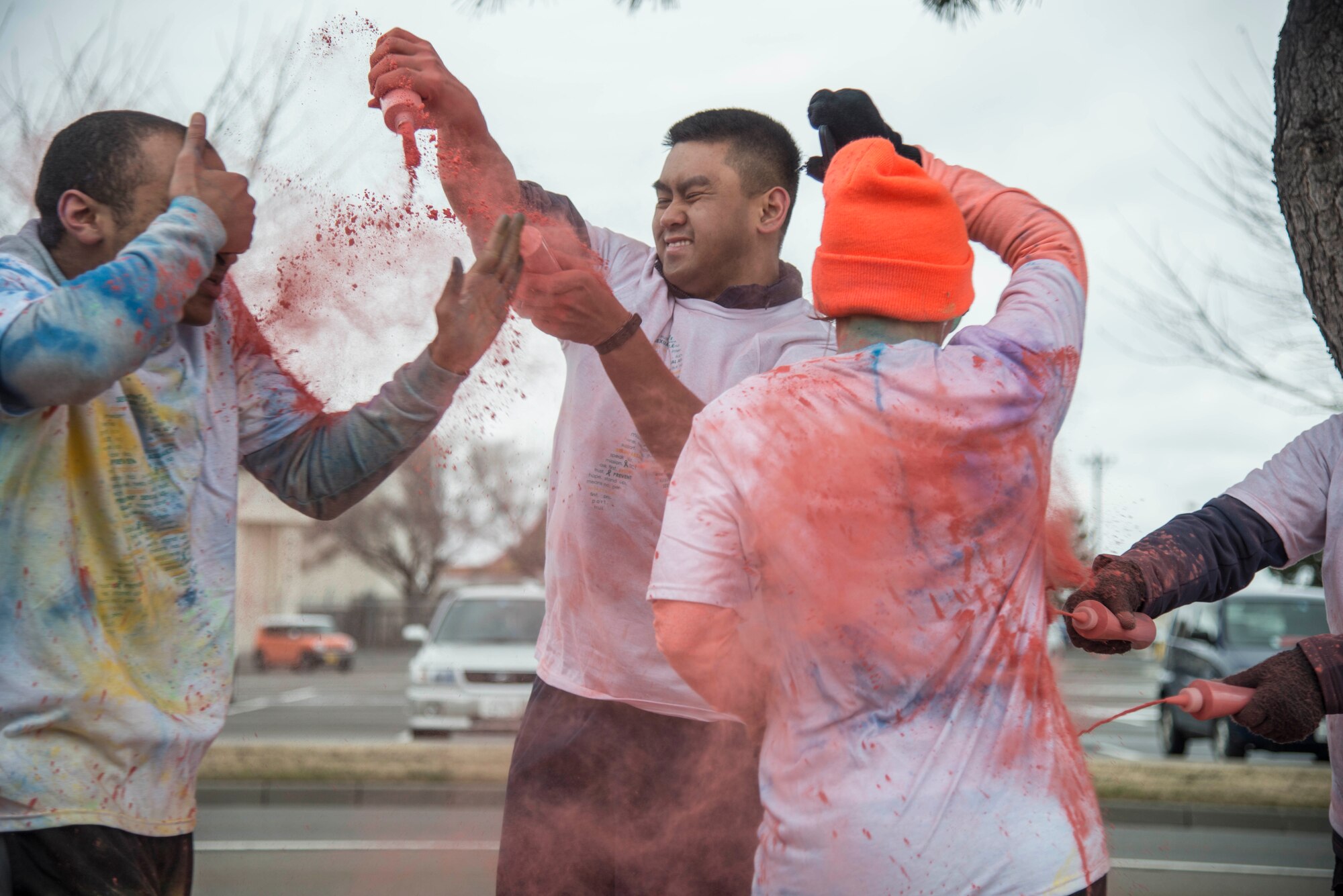 U.S. Air Force Airman 1st Class Francisco Valdepenas throws color on runners during Wingman Day at Misawa Air Base, Japan, March 31, 2017. Wingman Day included multiple events throughout the day, including a 3k color run. (U.S. Air Force Senior Airman Brittany A. Chase)