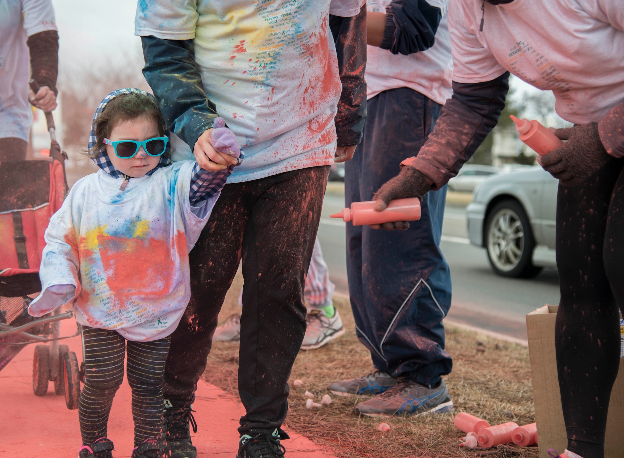 Evelyn, daughter of Staff Sgt. Steven Ramos, 35th Maintanence Squadron munitions control shift supervisor, gets color thrown on her while participating in a color run during Wingman Day at Misawa Air Base, Japan, March 31, 2017. Evelyn was one of nearly 100 participants in the run. (U.S. Air Force Senior Airman Brittany A. Chase)