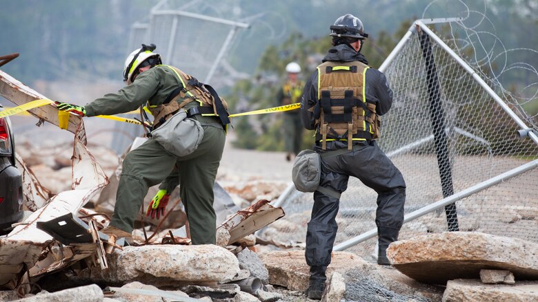 Staff Sgt. Tyler Jennings and Cpl. Austin Kirby, Marines with Technical Rescue Platoon, Chemical Biological Incident Response Force, close off a section of a collapsed building at Guardian Centers in Perry, Georgia, March 23, 2017 during Exercise Scarlet Response 2017.  During a 36-hour field operation, the Marines with CBIRF had to safely extract victims from a collapsed building in the aftermath of a simulated disaster. The field operation is the final event of the exercise.