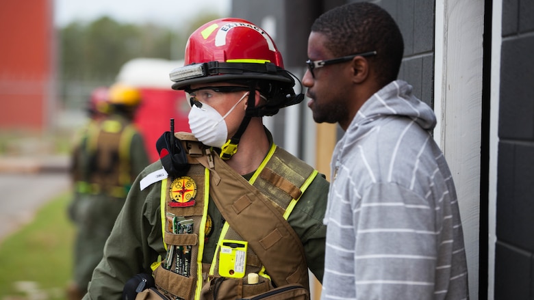 Lance Cpl. Carpenter Clark, a Marine with Extraction Platoon, Chemical Biological Incident Response Force, aids a victim out of a damaged structure at Guardian Centers in Perry, Georgia, March 23, 2017 during Exercise Scarlet Response 2017.  During a 36-hour field operation, the Marines with CBIRF had to safely extract victims from a collapsed building in the aftermath of a simulated disaster. The field operation is the final event of the exercise.