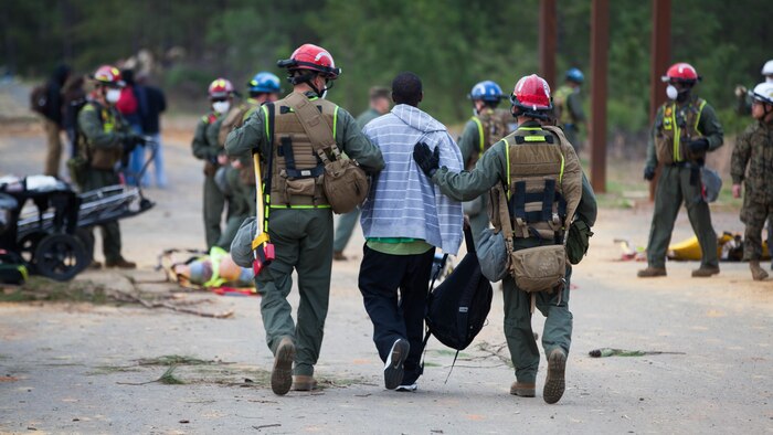 Lance Cpl. Valen Campion, left, and Lance Cpl. Carpenter Clark, both Marines with Extraction Platoon, Chemical Biological Incident Response Force, carry a victim to safety at Guardian Centers in Perry, Georgia, March 23, 2017 during Exercise Scarlet Response 2017.  During a 36-hour field operation, the Marines with CBIRF had to safely extract victims from a collapsed building in the aftermath of a simulated disaster. The field operation is the final event of the exercise.