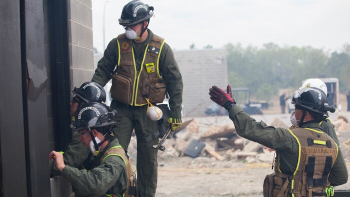 Marines with Technical Rescue Platoon, Chemical Biological Incident Response Force, prop open a pathway into a collapsed building at Guardian Centers in Perry, Georgia, March 23, 2017 during Exercise Scarlet Response 2017.  During a 36-hour field operation, the Marines with CBIRF had to safely extract victims from a collapsed building in the aftermath of a simulated disaster. The field operation is the final event of the exercise.