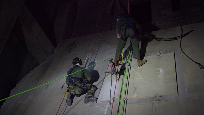 Sgt. Scott Stout, left, and Lance Cpl. Lukas Musselwhite, both Marines with Technical Rescue Platoon, Chemical Biological Incident Response Force, break through concrete from a collapsed building at Guardian Centers in Perry, Georgia, March 23, 2017 during Exercise Scarlet Response 2017.  During a 36-hour field operation, the Marines with CBIRF were tested on their ability to perform their skills during night time scenarios. The field operation is the final event of the exercise.