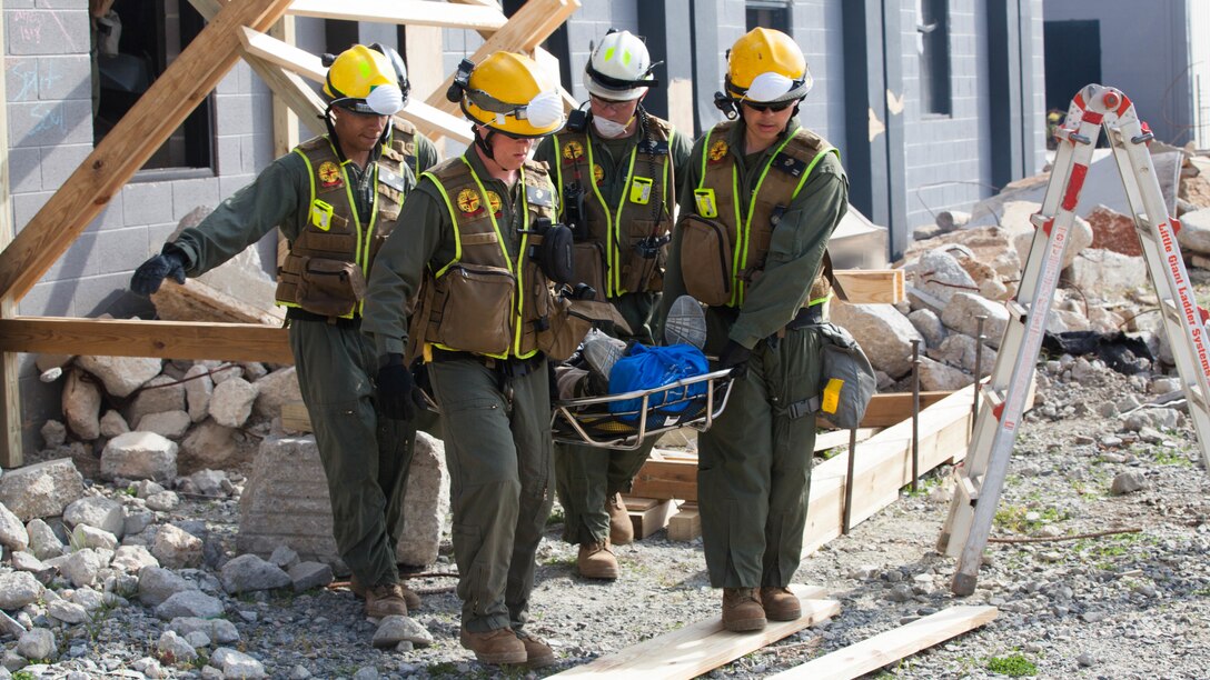 Marines with Chemical Biological Incident Response Force, extract and rescue a victim from a collapsed building at Guardian Centers in Perry, Georgia, March 23, 2017, during Exercise Scarlet Response 2017.  The Marines conducted a search and rescue during a 36-hour field operation in order to extract victims in a simulated disaster. The field operation is the final event of the exercise.