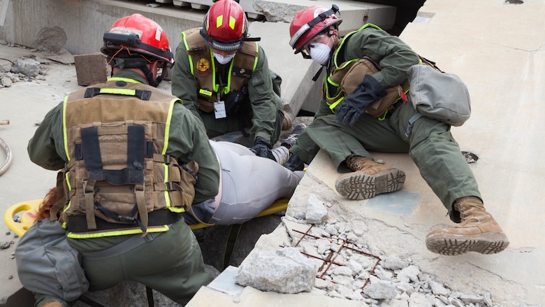 Marines with Chemical Biological Incident Response Force, extract and rescue a victim from a collapsed building at Guardian Centers in Perry, Georgia, March 23, 2017, during Exercise Scarlet Response 2017.  The Marines conducted a search and rescue during a 36-hour field operation in order to extract victims in a simulated disaster. The field operation is the final event of the exercise.