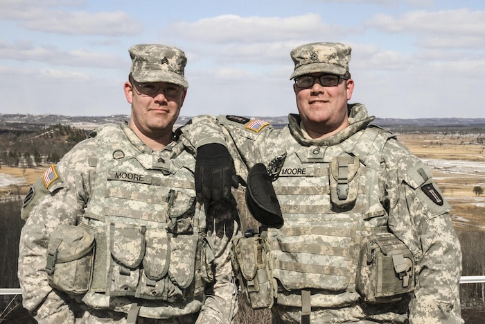 Army Reserve Staff Sgt. Jeshua Moore, left, and Sgt. Gereld Moore, both with the 327th Engineer Company, 416th Theater Engineer Command, are identical twins running gunnery crews at Operation Cold Steel 2017. Army photo by Staff Sgt. Debralee Best