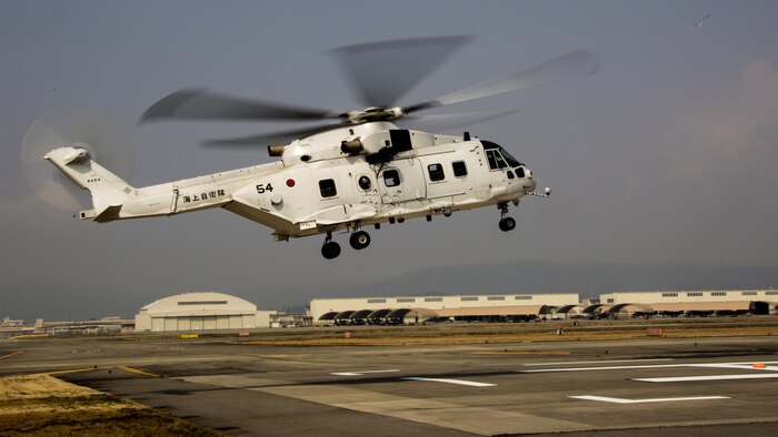 A Japanese MCH-101 airborne mine countermeasures helicopter lands on a heliport designated by Marine Air Control Squadron 4 Detachment B during a cross-training exercise at Marine Corps Air Station Iwakuni, Japan, March 30, 2017. The purpose of the exercise was to simulate a forward arming and refueling points operation, where Marines communicated with Japan Maritime Self-Defense Force helicopter pilots to perform austere landings on a heliport that acted as an expeditionary runway.
