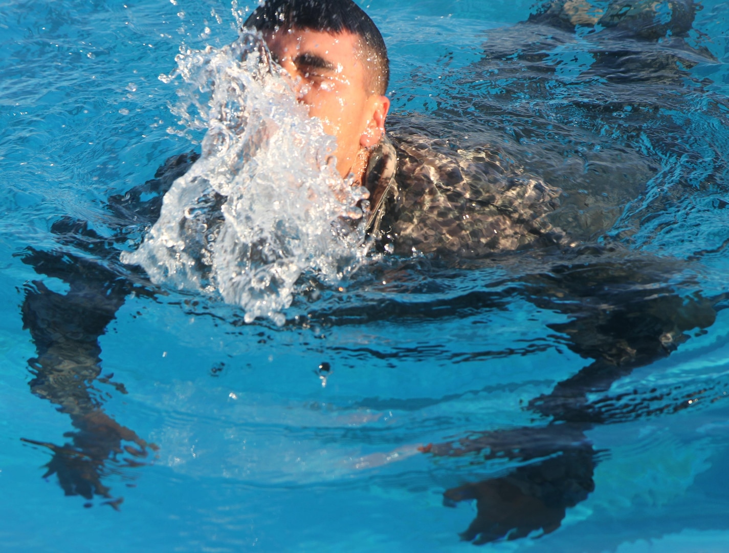 A U.S. Army Soldier exhales as he swims 100-meters as part of the German Armed Forces Proficiency Badge testing at the Fort Sam Houston Aquatics Center at Joint Base San Antonio-Fort Sam Houston March 31.