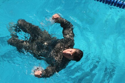 A U.S. service member treads water before removing his uniform as part of the German Armed Forces Proficiency Badge test at the Fort Sam Houston Aquatics Center at Joint Base San Antonio-Fort Sam Houston March 31. 