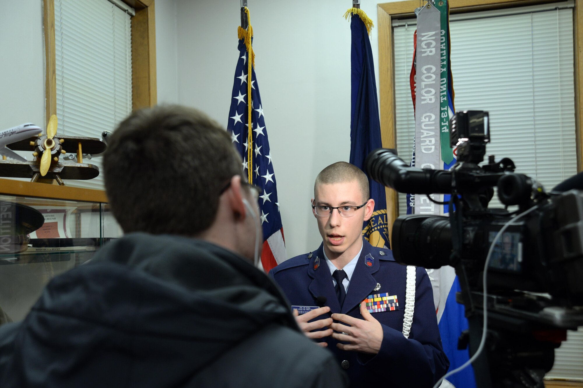 Cadet Chief Master Sgt. Any Robichaux is interviewed by local media at the Curtis E. LeMay Composite Squadron's open house March 30 at their squadron headquarters. The event showcased a new state-of-the-art cybersecurity and science, technology, engineering and mathematics (STEM) learning environment made possible by grants from a local corporate sponsor, the Offutt Officers’ Spouses’ Club and an anonymous donor. 

About 56,000 members make up CAP, which celebrated 75 years of service on Dec. 1, 2016, and consists of eight geographical regions, composed of 52 separate wings, one in each state, and Washington D.C. and Puerto Rico. The organization operates a fleet of 550 aircraft and performs about 90 percent of continental U.S. inland search and rescue missions as tasked by the Air Force Rescue Coordination Center. CAP is credited with saving an average of 78 lives every year.