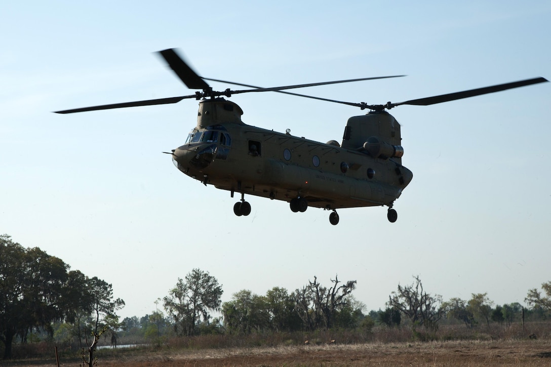An Army CH-47 Chinook helicopter prepares to land during aerial firefighting exercise Operation Vigilant Guard in Ellabell, Ga., March 29, 2017. The helicopter crew is assigned to the Georgia Army National Guard’s Detachment 1, Company B, 1st Battalion, 169th Aviation Regiment. The exercise provides National Guard units with opportunity to improve on cooperation and relationships with not only local and state agencies, but military and federal partners as well for emergencies and catastrophic events. Army photo by Spc. Josue Mayorga