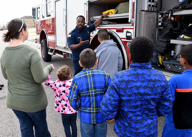 SCHRIEVER AIR FORCE BASE, Colo.—Dwayne Peeples, Schriever Air Force Base Fire Department firefighter, gives a tour of one of SFD trucks and briefs Parent Enrichment Spring Celebration and Craft Activity attendees on various tools and equipment at Schriever Air Force Base, Colorado, Wednesday,  March 29, 2017. The SFD not only brought out one of their trucks, but also had Sparky the Fire Dog on hand for the event. (U.S. Air Force photo/ Staff Sgt. Matthew Coleman-Foster)
