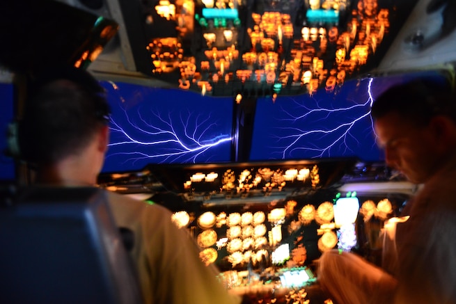 Pilots of a KC-10, from the 78th Air Refueling Squadron, 514th Air Mobility Wing, experience a phenomenon called St. Elmo&#39;s fire while flying through a thundercloud overseas. St. Elmo&#39;s fire occurs when the electric field around the aircraft causes ionization of the air molecules, producing a glow and sparks. It is easily visible in low-light conditions (Air Force photo by Senior Airman Brian Kelly/released)