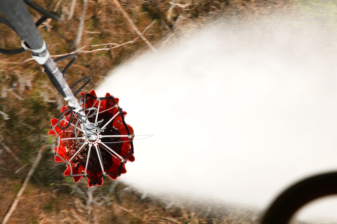An Army CH-47 Chinook helicopter drops water from a bucket firefighting system while participating in aerial firefighting exercise Operation Vigilant Guard in Ellabell, Ga., March 29, 2017. Army photo by Spc. Josue Mayorga