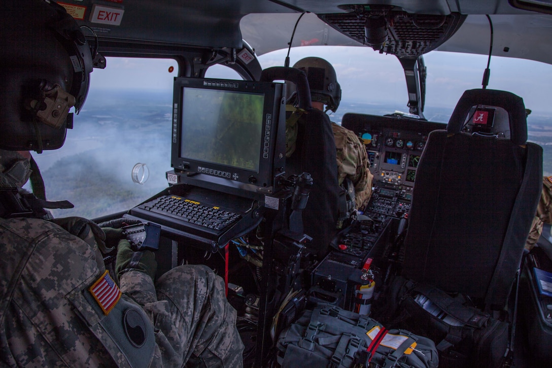 Georgia Army National Guardsmen observe aerial firefighting exercise in a UH-72 Lakota helicopter during Operation Vigilant Guard in Bryan County, Ga., March 29, 2017. Army photo by Spc. Jesse Coggins