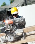 Spc. Jose Santiago with the 471st Engineer Company (Vertical), 448th Eng. Battalion, an Army Reserve unit based out of Guaynabo, Puerto Rico, cuts through a 4x4 support beam that will be used to shore up decks surrounding the bathrooms and showers at Price Barracks, Belize, March 20, 2017. Soldiers from the 471st spent 20 days building the living and operations areas for personnel supporting Beyond the Horizon 2017, a partnership exercise between U.S. Army South and the Belize government that will consist of various medical events and construction projects throughout Belize.