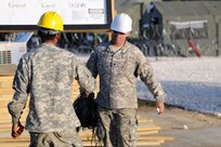 Staff Sgt. Jose Morales (right), an engineer squad leader, turns in a bundle of electrical wire to Spc. Kenyi Moreno, a plumbing engineer and the task force tool supply technician, on the final day of construction for the 471st Engineer Company (Vertical), 448th Engineer Battalion, based out of Guayanabo, Puerto Rico, March 24, 2017. These engineers were tasked with creating a forward operating base to support and sustain personnel participating in Beyond the Horizon 2017, a partnership exercise between U.S. Army South and the Belize government that will consist of various medical events and construction projects throughout Belize