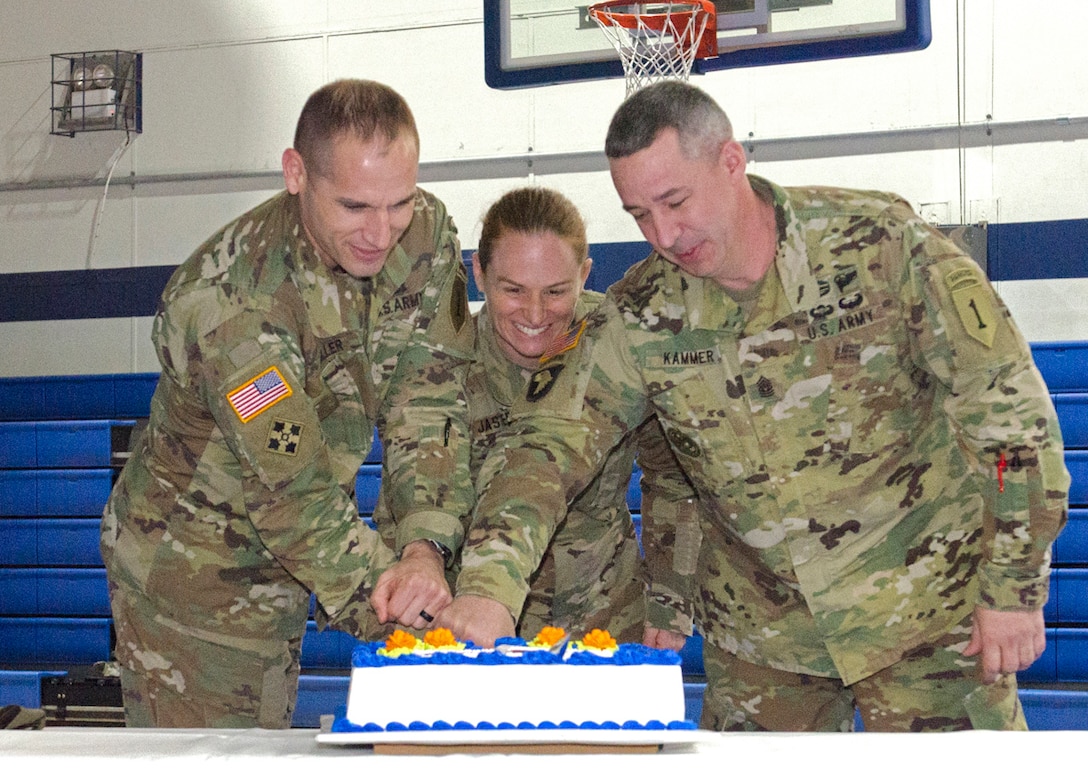 CAMP HOVEY, South Korea – Lt. Col. Scott Miller (left), the commander of the 1st Engineer Battalion, 1st Armored Brigade Combat Team, 1st Infantry Division, Maj. Lisa Jaster (center), the third woman to graduate from the U.S. Army Ranger School, and Command Sgt. Maj. Toby Kammer (right), the senior enlisted leader of the 1st En. Bn., 1st ABCT, cut a celebratory cake during a Women’s History Month observance at the Camp Hovey physical fitness center, Camp Hovey, South Korea, March 30. During the observance, Jaster shared her experiences of being in the Army as a female Soldier. (U.S. Army Photo by Sgt. Dasol Choi, 1st ABCT, 1st Inf. Div. Public Affairs)