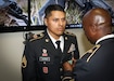 Command Sgt. Major Ronnie Farmer, command sergeant major for the 335th Signal Command (Theater), presents the Army Commendation Medal to Army Reserve Staff Sgt. Erick Guzman, information technology staff noncommissioned officer, assigned to the 820th Signal Company, 98th Expeditionary Signal Battalion, 335th SC (T), during an awards ceremony at the command’s 2017 Best Warrior Competition at Fort Huachuca, Arizona March 31.  After five-days of demanding physical and mental challenges Guzman was named the command’s Best Warrior for the noncommissioned officer ranks, and will go on to represent the command at the U.S. Army Reserve Command’s Best Warrior Competition later this year.  (Official U.S. Army Reserve photo by Sgt. 1st Class Brent C. Powell)