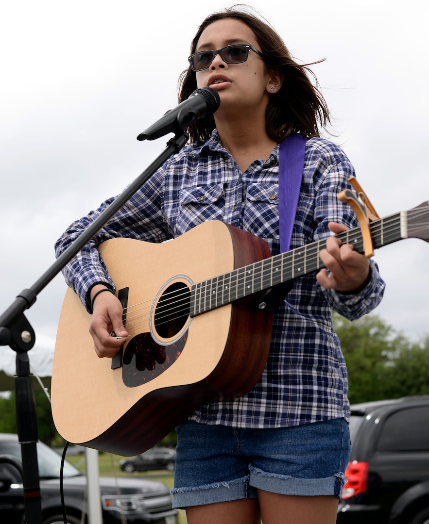 Malia A. Barker sings and entertains the crowd during the Cowboys for Heroes event Joint Base San Antonio-Fort Sam Houston’s MacArthur Parade Field April 1.