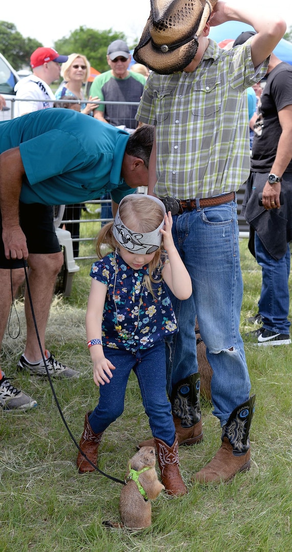 Kinley S. Royse plays with a groundhog at the petting zoo during the Cowboys for Heroes event Joint Base San Antonio-Fort Sam Houston’s MacArthur Parade Field April 1.