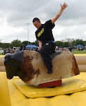 A Soldier rides the mechanical bull during the Cowboys for Heroes event Joint Base San Antonio-Fort Sam Houston’s MacArthur Parade Field April 1.