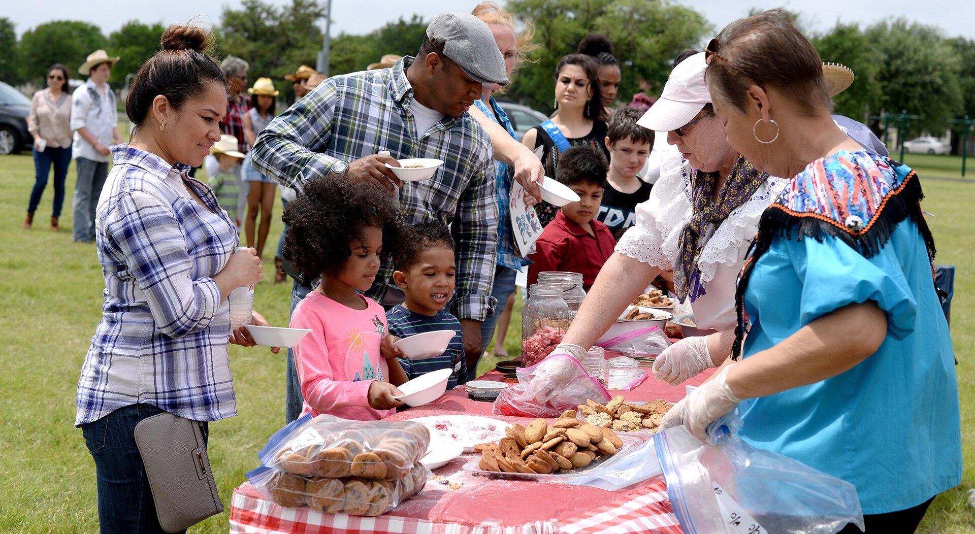 Military families line up at the cookie and candy station during the Cowboys for Heroes event Joint Base San Antonio-Fort Sam Houston’s MacArthur Parade Field April 1.