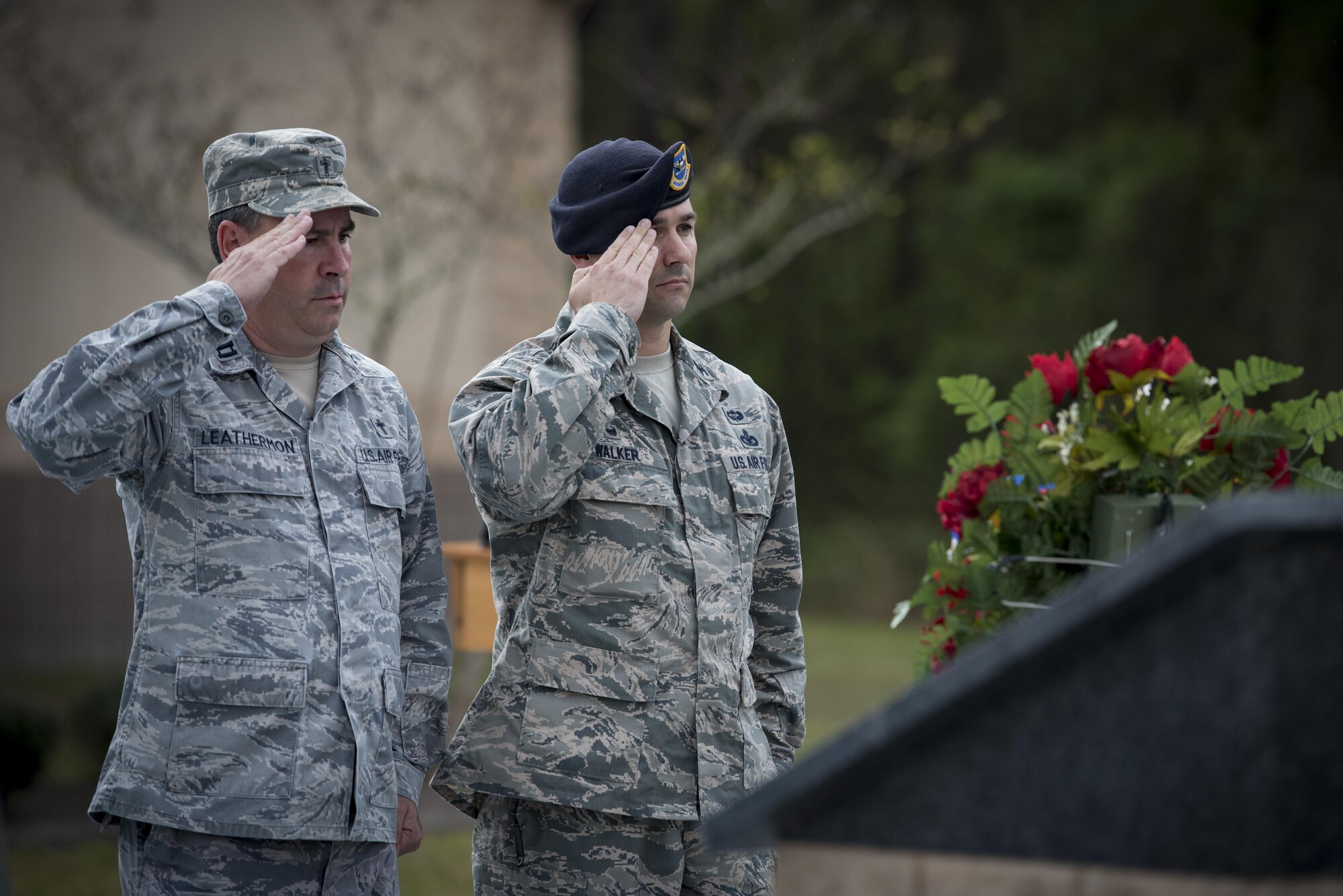 Chaplain (Capt.) Todd Leathermon, 93d Air Ground Operations Wing chaplain, left, and Col. Kevin Walker, 820th Base Defense Group commander, right, salute a wreath and memorial during the 820th BDG anniversary, March 27, 2017, at Moody Air Force Base, Ga. The anniversary commemorated 20 years since the activation of the 820th BDG and allowed guests to reminisce on their history, honor those they’ve lost, and witness a tactical demonstration. (U.S. Air Force photo by Airman 1st Class Lauren M. Sprunk)