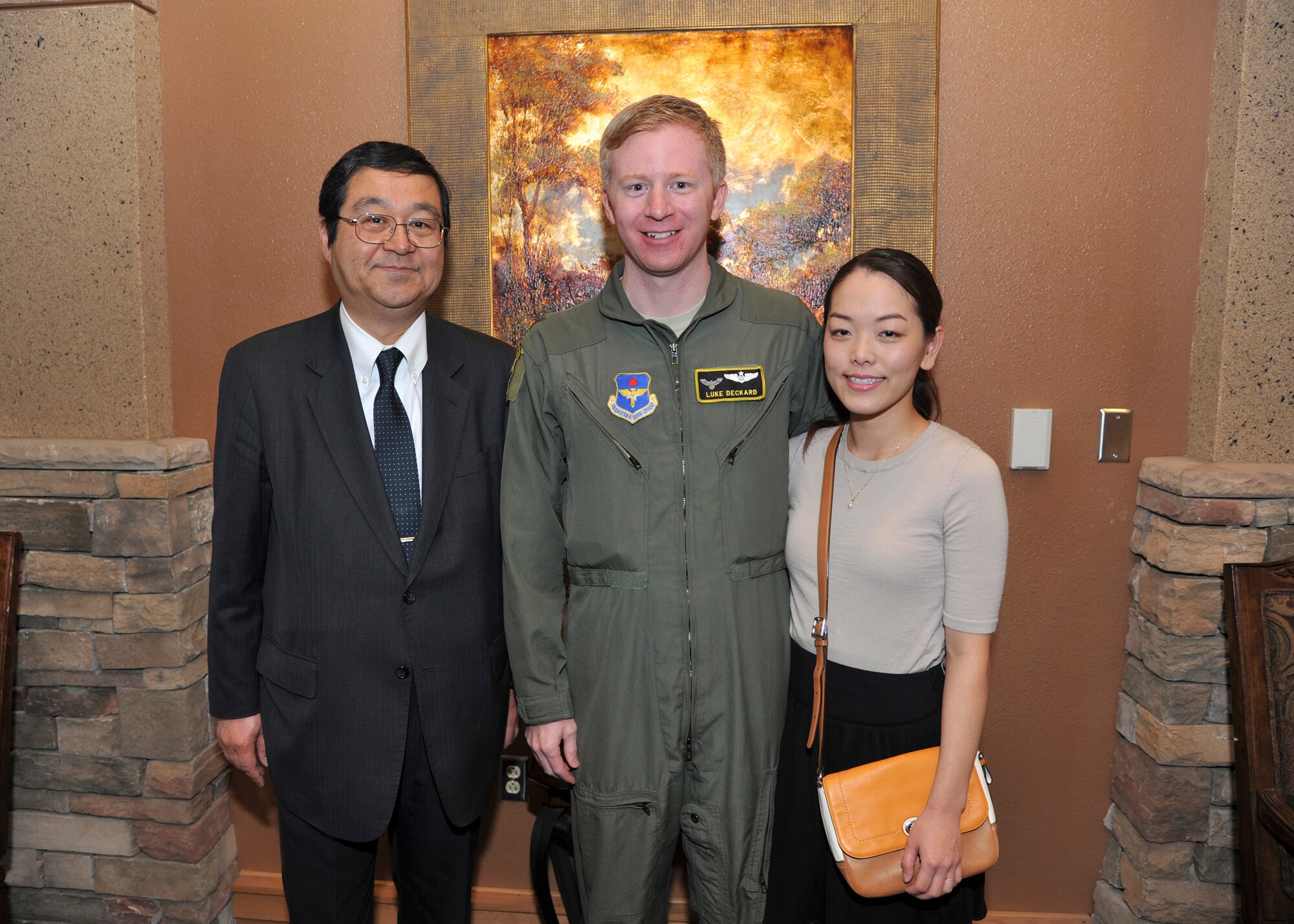 Consul-General of Japan Hiroto Hirakoba takes a photo with Maj. Michael Deckard, 58th Special Operations Wing combat systems officer, and his wife Ayume, during a lunch reception at the Mountain View Club March 31. Deckard spoke at the luncheon on his positive experiences during his time in Japan. 