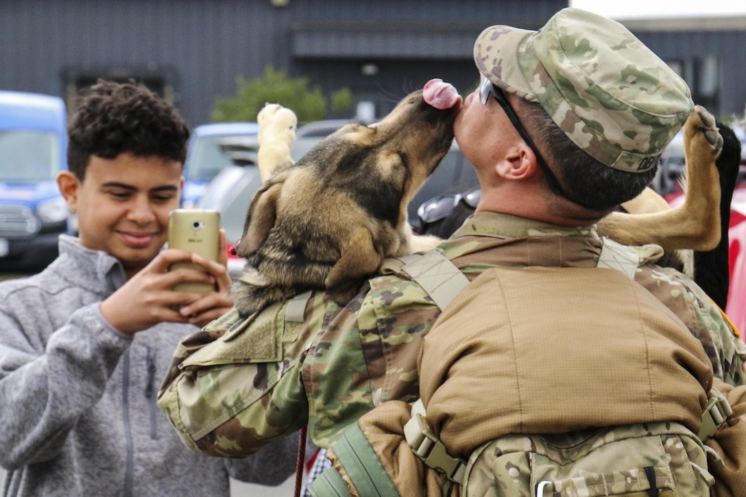 A Virginia Army National Guardsmen receives a welcome home kiss at Dulles International Airport, Va., April 1, 2017, upon returning from a deployment. Soldiers assigned to the 1st Battalion, 116th Infantry Brigade Combat Team returned from Qatar, where they conducted security operations beginning in May 2016. Army National Guard photo by Sgt. Amanda H. Johnson