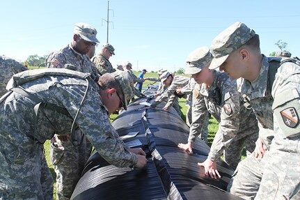 Louisiana National Guard Soldiers of the 2225th Multi-Role Bridge Company, 225th Engineer Brigade, conduct patch training on the Aqua Dam system during the Disaster Relief Exercise at the Bonnet Carre Spillway, St. Charles Parish, April 1, 2017. Aqua Dams are water filled cofferdams that are used for flood control and protection. 