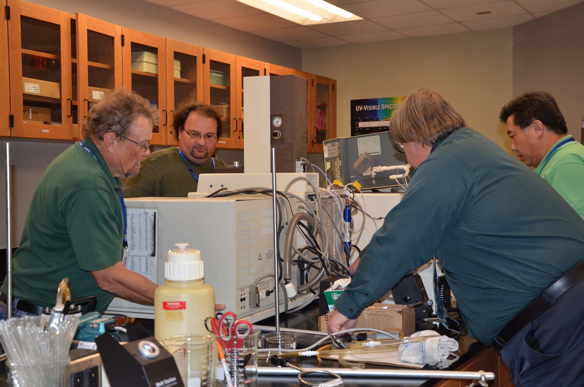George Kenney, left, and Scott Herber, second from left, help Dr. Dan Mackney and Dr. Zhengrong Lee place a mass spectrometer on a lab table at Eastern Florida State College March 17, 2017.  Mackney and his co-workers from the Air Force Technical Applications Center, Patrick AFB, Fla., assisted Kenney, Herber and Lee, all science professors at EFSC, procure lab analysis equipment from an anonymous Central Florida donor. (U.S. Air Force photo by Susan A. Romano)