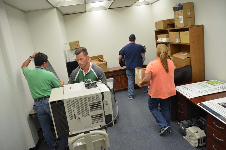 Members of the Air Force Technical Applications Center and faculty from Eastern Florida State College position newly-procured laboratory analysis equipment from an anonymous Central Florida donor to the college March 17, 2017.  AFTAC personnel were asked to assist the school with ensuring the equipment was functional and operable.  Pictured from left to right:  Dr. Zhengrong Lee, Brett Maptson, Bart Scarbro and Maria Fraley.  (U.S. Air Force photo by Susan A. Romano)