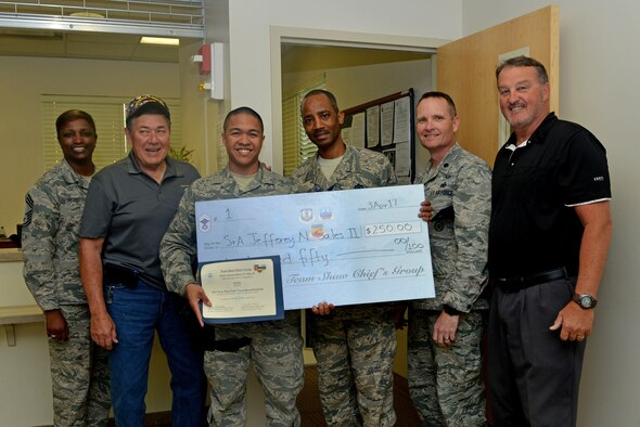 U.S. Air Force Senior Airman Jefferey N. Sales, II, 20th Security Forces Squadron visitor control center clerk, receives the Shaw Chief’s Group Spring Scholarship at Shaw Air Force Base, S.C., April 3, 2017. The Shaw Chief’s Group awarded Sales the scholarship for his essay about joining the military and his current goals. (U.S. Air Force photo by Airman 1st Class Destinee Sweeney)