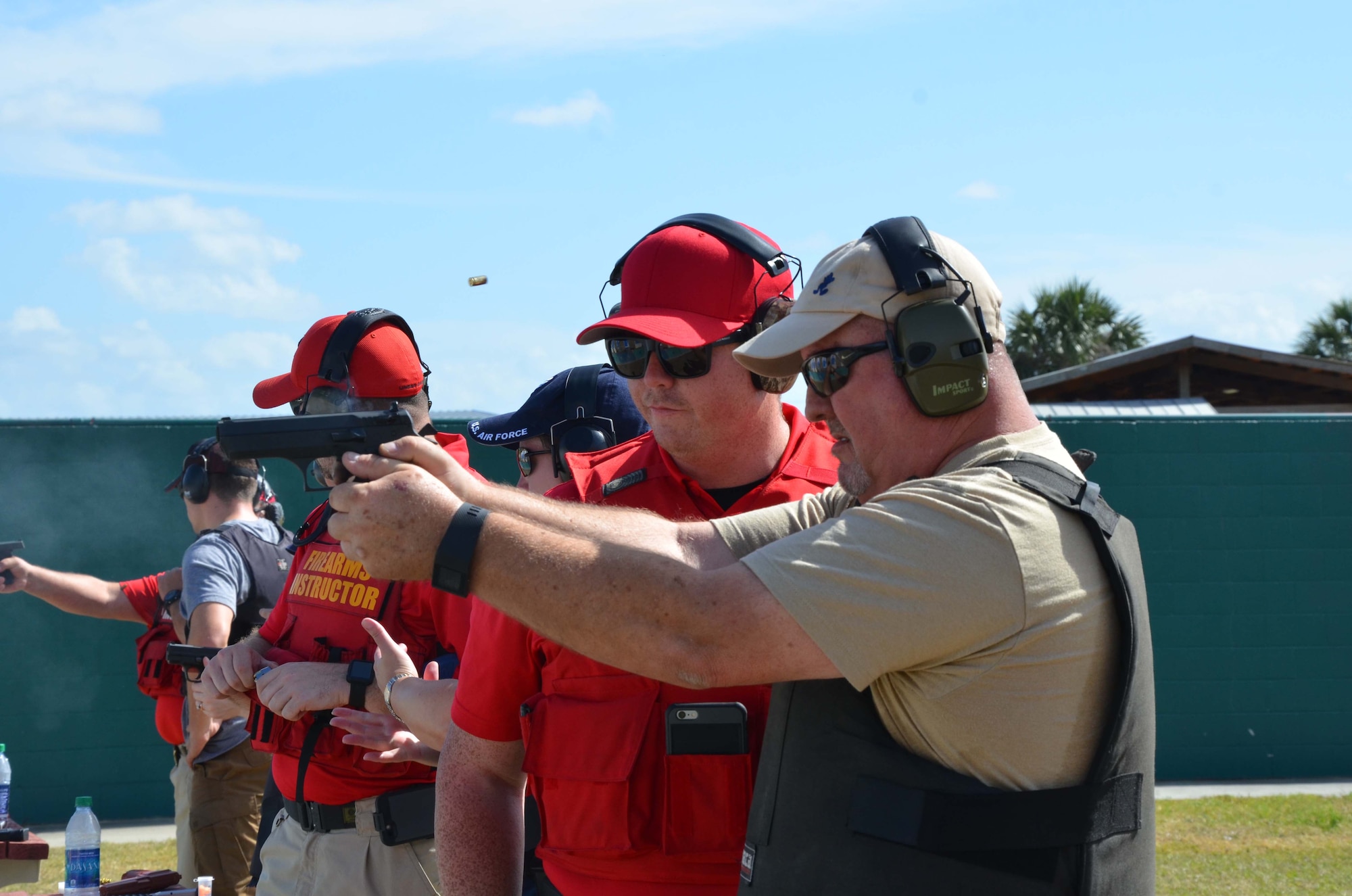 Jim Ordway (right) a member of the Air Force Technical Applications Center, Patrick AFB, Fla., fires off a round as Agent Reggie Hammond, a deputy with the Brevard County Sheriff’s Office, observes.  Ordway was one of 25 AFTAC members who attended BCSO’s Self Defense Through Tactical Shooting and Decision Making course March 25, 2017.  (U.S. Air Force photo by Susan A. Romano)